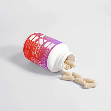 Ash Stress Relief Capsules bottle open with capsules on white surface