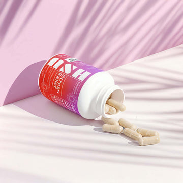 Ashwagandha Stress Relief bottle with capsule spill on soft fabric